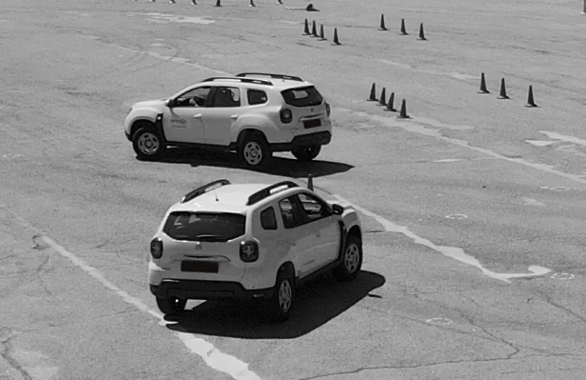 Два автомобілі на навчальному майданчику з конусами